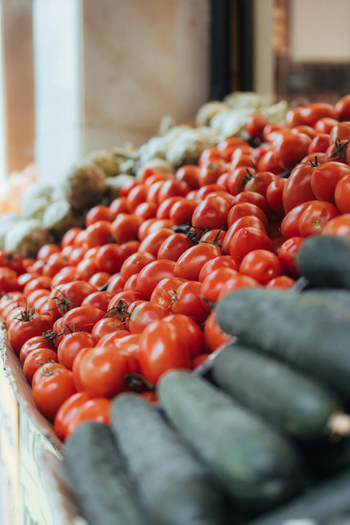 pexels photo 32495172 32495172 Vibrant tomatoes and cucumbers on display at a local market in Barcelona, Spain.