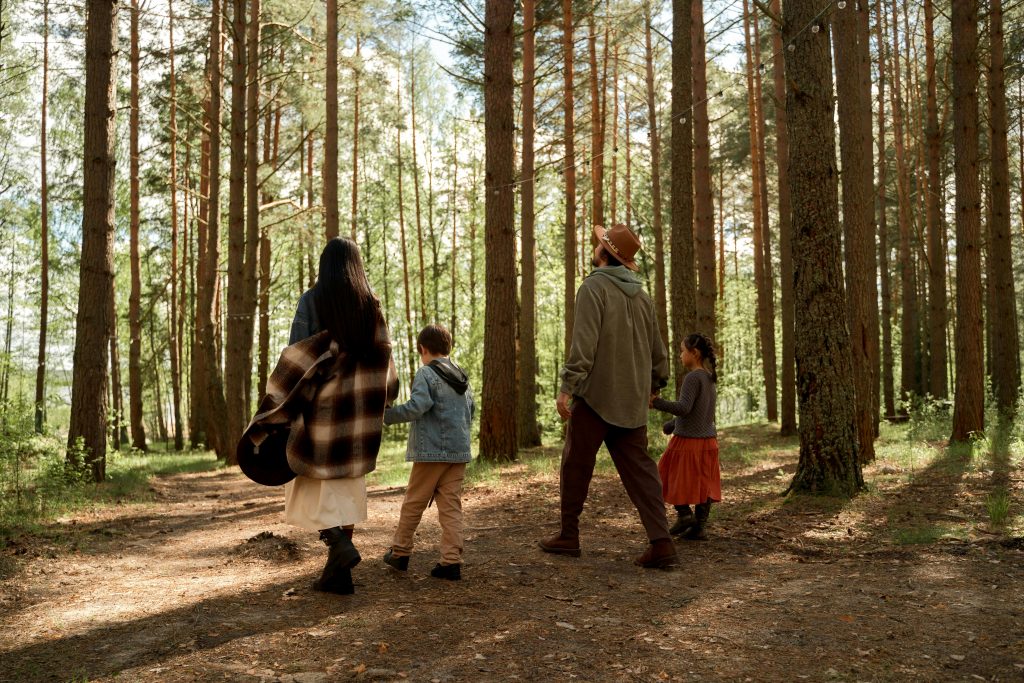 pexels photo 9220732 9220732 A family enjoys a peaceful walk through a sunlit forest, embracing nature and togetherness.